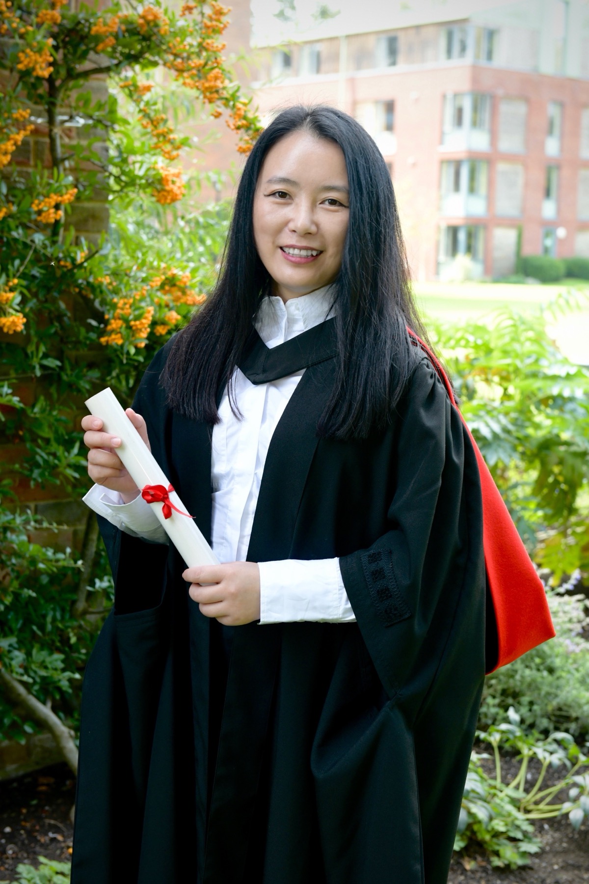 Dr Min in University of Cambridge graduation robes